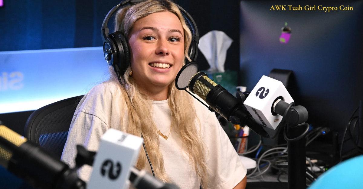 A young woman with long blonde hair name AWK Tuah Girl wearing headphones and speaking into a professional microphone in a podcast studio. She is smiling and appears engaged in conversation. The background features a computer monitor, a tissue box, and podcasting equipment. The text "AWK Tuah Girl Crypto Coin" is visible in the top right corner.